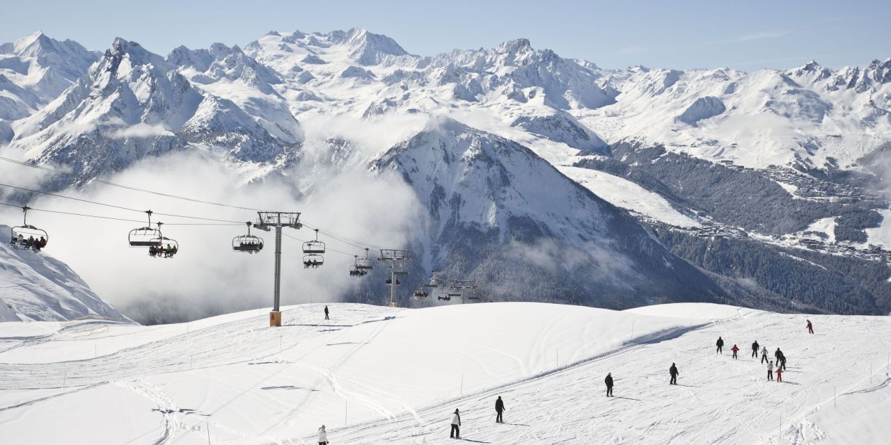 Skiers on the sunny slopes of the Paradiski area