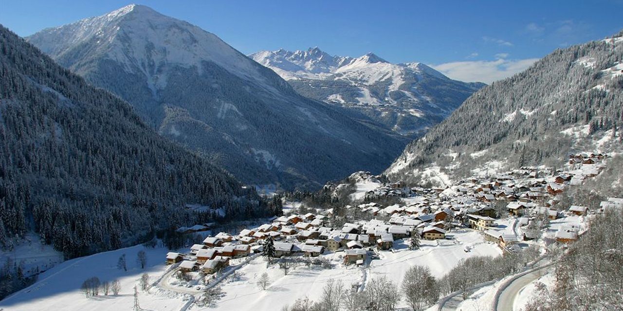 Snow-covered village of Champagny en Vanoise under the peaks