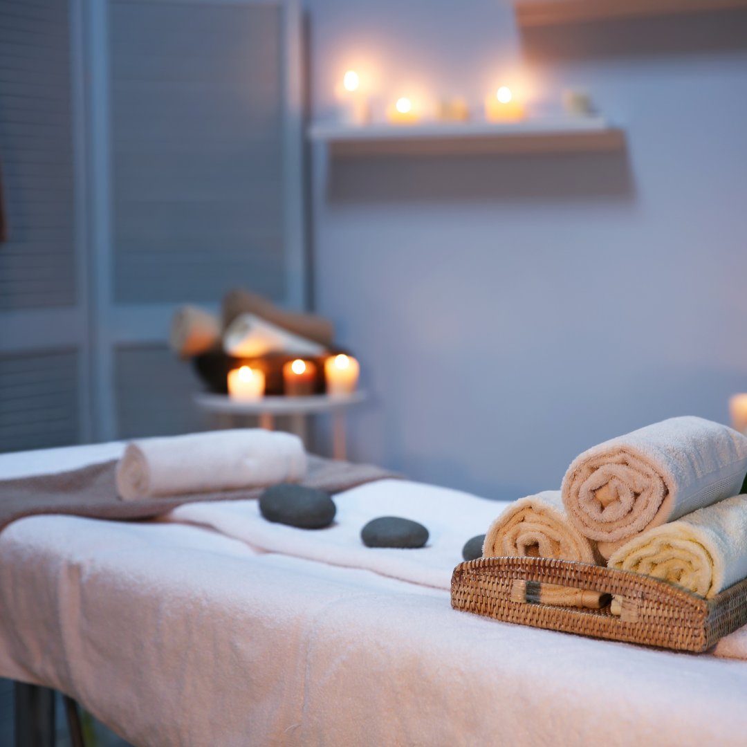 Massage table with towels, stones and candles
